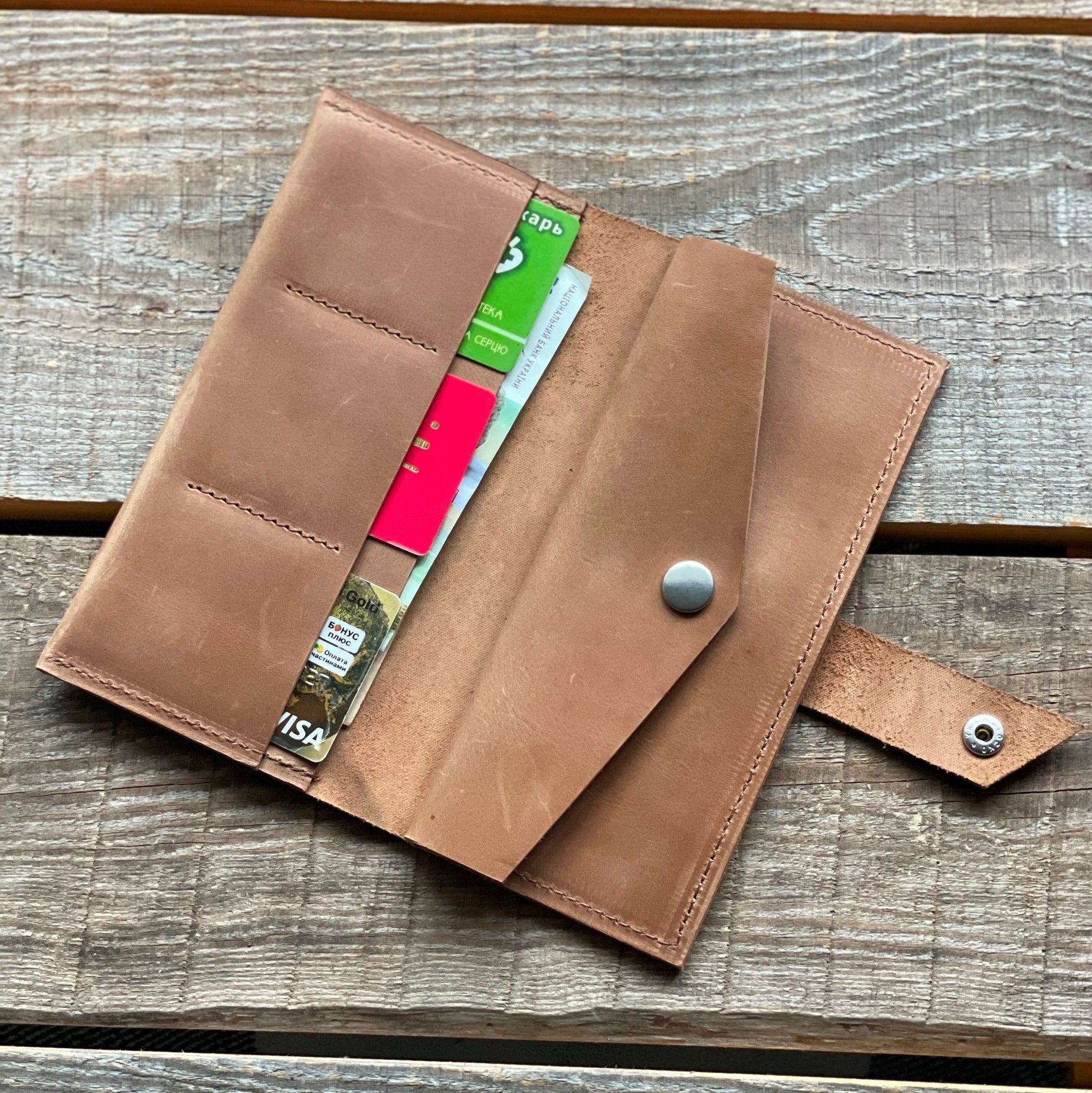 Portfel damski z włożonymi monetami do specjalnej, zabezpieczonej kieszeni.

