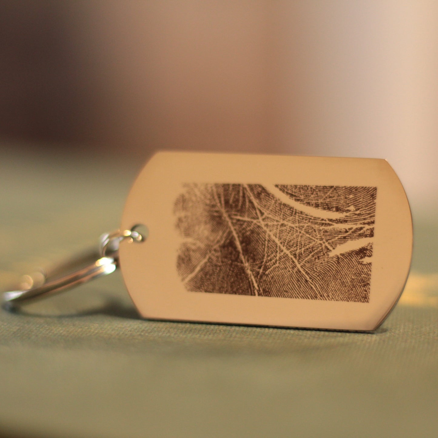 Personalizowany brelok pamiątkowy z grawerowaniem dwustronnym - odcisk palca z jednej strony, dedykacja z drugiej.

